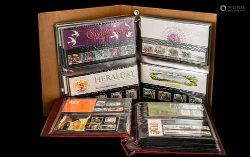 Two Stamp Albums - containing mostly stamps in presentation packs, but also some first day covers.