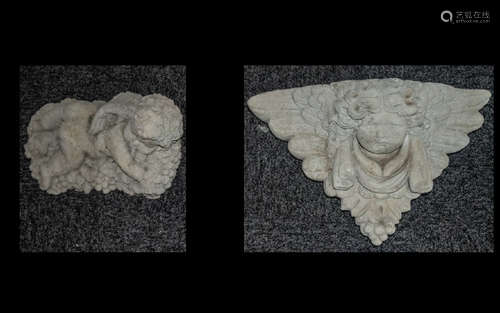 Pair of Stone Cherub's - small cherub lying on a bed of grapes and a wall mounted plaque of a