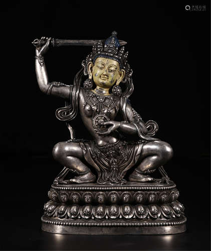 TIBETAN SILVER SEATED BUDDHIST GUARDIAN WITH SWORD