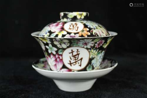 A Chinese Black Ground Famille-Rose Porcelain Tea Bowl with Cover and Plate