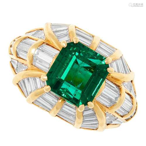 AN EMERALD AND DIAMOND RING set with an emerald cut