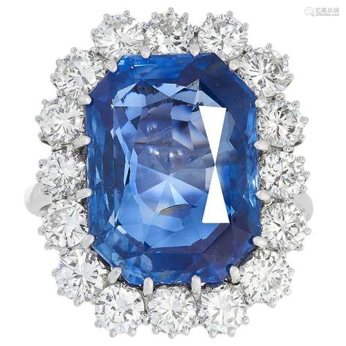 A SAPPHIRE AND DIAMOND CLUSTER RING set with a cushion