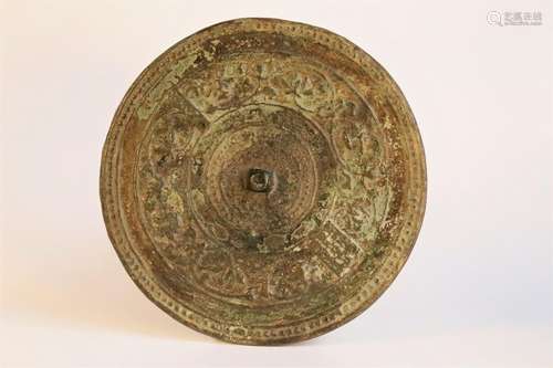 A round bronze 'flower'mirror