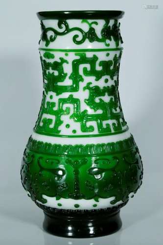 A carved green glass overlay vase