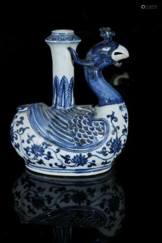 A blue and white vase in shape of bird