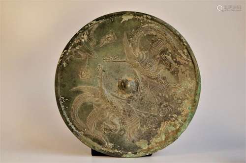 A round bronze 'peafowl'mirror