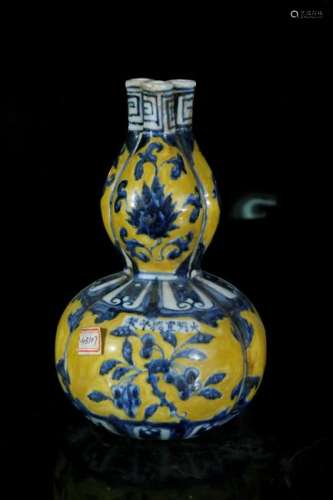 A yellow glaze with blue and white vase in shape of