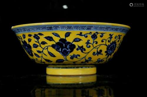 A yellow glaze with blue and white 'flower' bowl