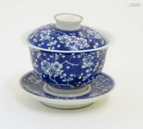A Chinese blue and white tea bowl, lid and saucer,
