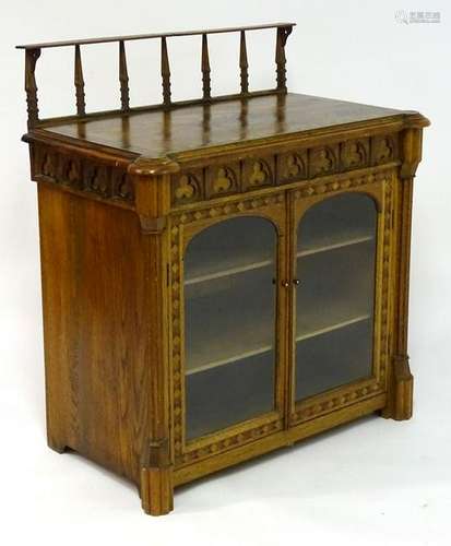 A mid / late 19thC oak Gothic cabinet, having a raised