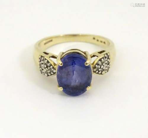 An 18ct gold tanzanite and diamond ring, the central