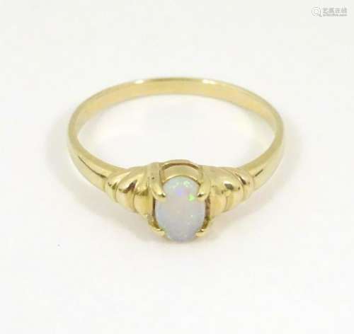 A 14k gold ring set with opal cabochon.