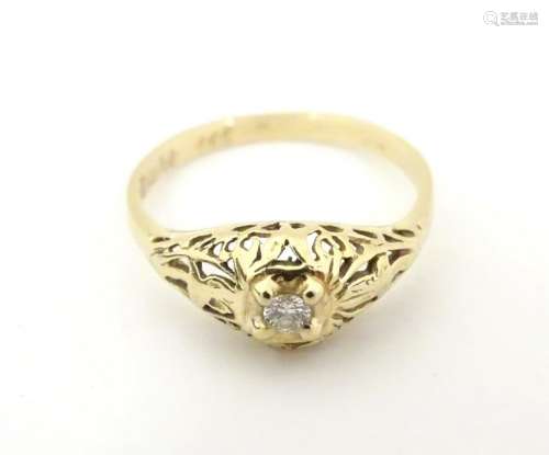 A gold ring set with central diamond