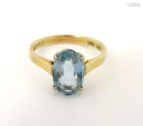 A 14ct gold ring set with oval aquamarine