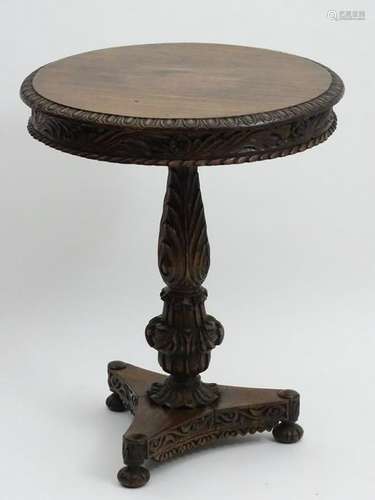 A mid 19thC Anglo-Indian table with a circular carved