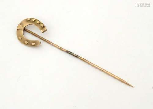 A Victorian 9ct gold stick pin surmounted by a