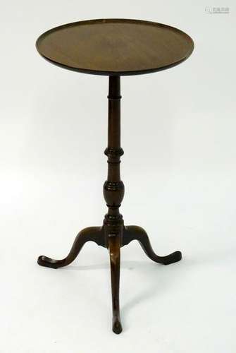 An early 20thC mahogany tripod table with a circular