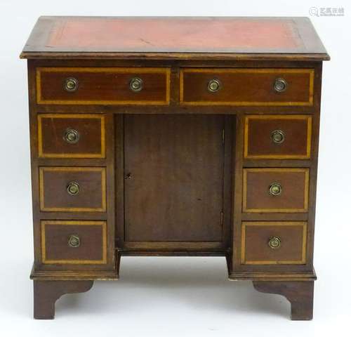 An early 20thC mahogany kneehole desk, having an inset