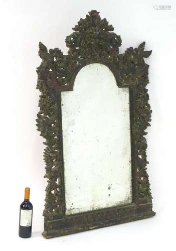 A late 19thC mirror with a carved painted frame and