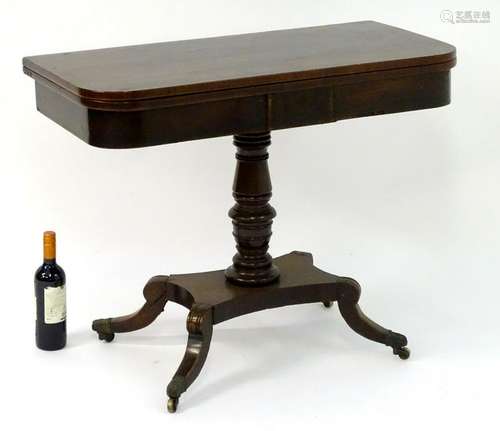 A mid 19thC mahogany fold over tea table with a