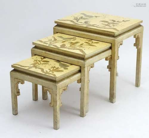 An early 20thC nest of three tables oriental tables