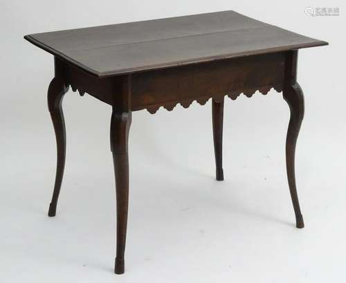 A 19thC continental walnut table with a rectangular top