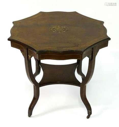 An early 20thC rosewood table with an octagonal shaped