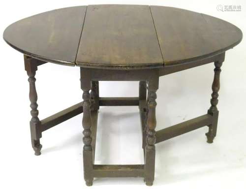 An 18thC oak gateleg table with drop leaves to each