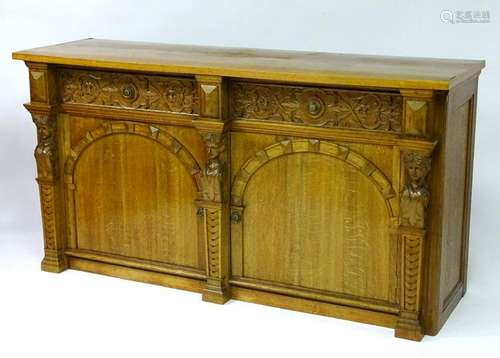 A mid 20thC oak sideboard with a rectangular top above