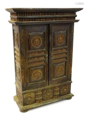 A 19thC Middle Eastern cabinet with a moulded cornice