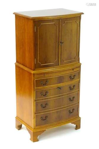 A late 20thC / 21stC yew cocktail cabinet, having a bow