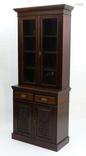 An Edwardian mahogany glazed bookcase, having a moulded