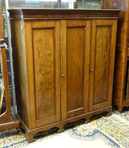 An early 20thC mahogany wardrobe with a moulded cornice