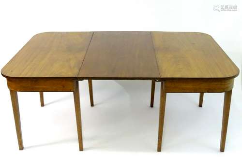 A 19thC mahogany D-ended dining table raised on