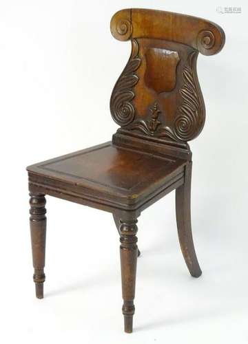 A mid 19thC mahogany hall chair with a lyre shaped