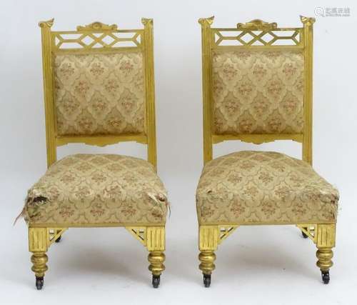 A pair of early 20thC gilt nursing chairs with a