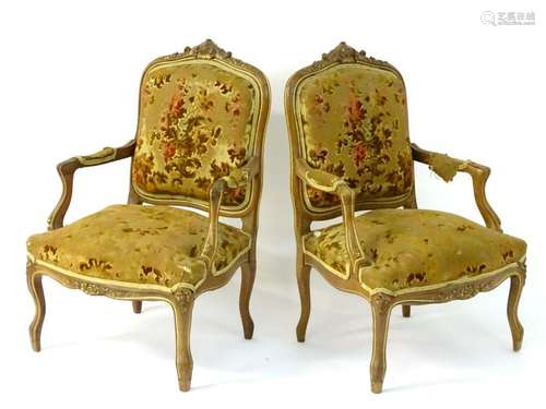 A pair of early-20thC fauteuil armchairs, the walnut