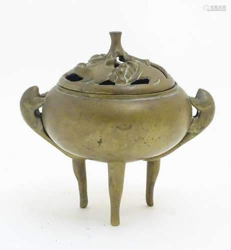 A Chinese three footed brass lidded censer with tailed