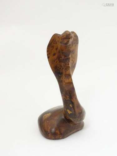 An early 20thC carved amboyna formed as a rearing King