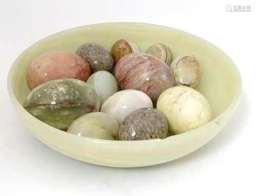 A turned onyx bowl, together with 12 egg shaped hand