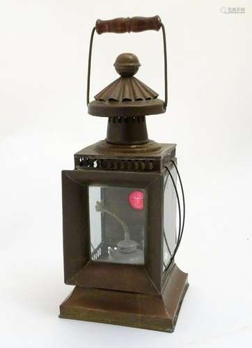 A copper cased, hinged handled oil lamp with bevelled