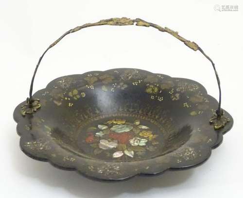 A Victorian papier mache cake basket with swing handle