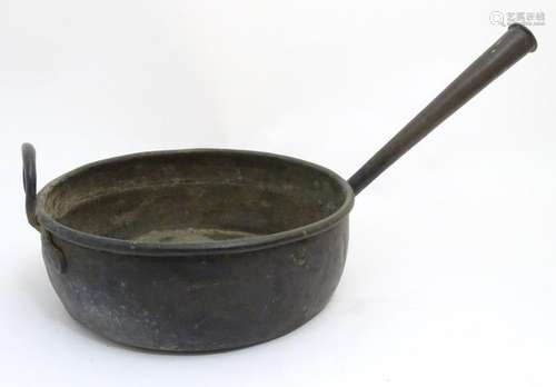 A large 19thC copper cooking pan with a tapering hollow