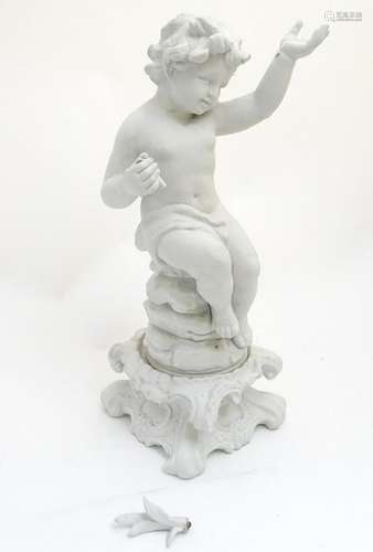 A 19thC German bisque figure of a seated Putti on a