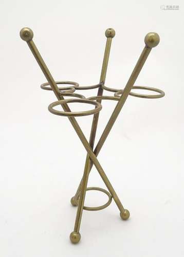 An umbrella / parasol stand of brass form surmounted by