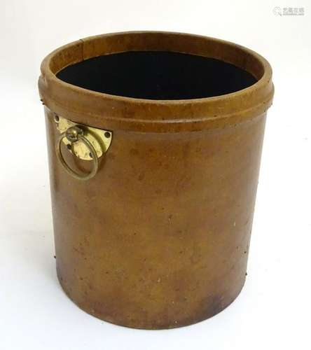 A leather cylindrical shaped waste paper bin with brass