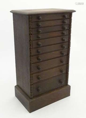 Collectors cabinet: a late 19thC small oak chest of 10