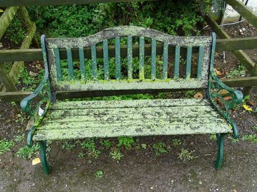 Garden bench: a teak and green painted cast iron 2 seat