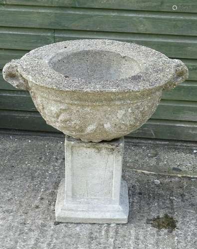 A reconstituted stone urn with associated squared