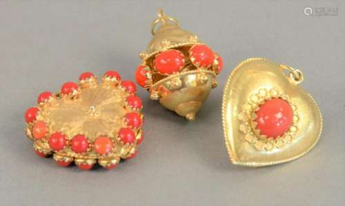 Three large 18K gold charms with red stones, 35.7 grams